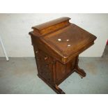 A LEATHER INLAID DAVENPORT WRITING DESK MADE BY RAY & MILES