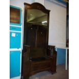 AN ANTIQUE OAK HALL STAND WITH BENCH AND STORAGE