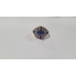 AN ART DECO-STYLE PLATINUM DRESS RING SET WITH A CENTRAL CABOCHON SAPPHIRE AND FURTHER DIAMONDS