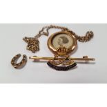 A 9 CT GOLD SOUTH STAFFORDSHIRE REGIMENT BROOCH AND A YELLOW METAL LOCKET AND CHAIN, TOGETHER WITH A