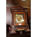 AN ANTIQUE CARVED MAHOGANY BRACKET CLOCK BY JUNGHANS, STRIKING ON BARS, A/F