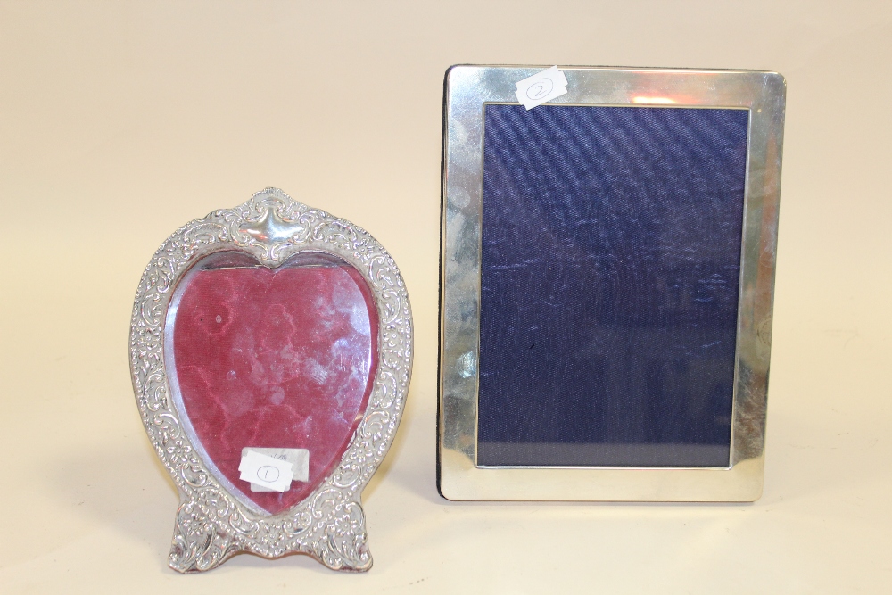 TWO HALLMARKED SILVER PICTURE FRAMES TO INCLUDE A HEART SHAPED EXAMPLE- LARGEST OVERALL - 22 X 16.