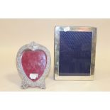 TWO HALLMARKED SILVER PICTURE FRAMES TO INCLUDE A HEART SHAPED EXAMPLE- LARGEST OVERALL - 22 X 16.