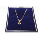 A 9CT GOLD FLORAL PENDANT ON CHAIN