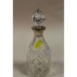 A SMALL CUT GLASS HALLMARKED SILVER COLLARED DECANTER