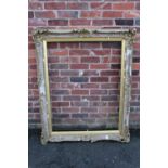 A 19TH CENTURY GOLD SWEPT FRAME WITH INTEGRAL SLIP A/F, frame W 10 cm, rebate approx 113 x 87 cm