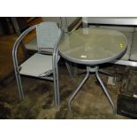 A CIRCULAR GLASS TOPPED TABLE & TWO CHAIRS
