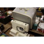 A VINTAGE CASED FRISTER & ROSSMAN ELECTRIC SEWING MACHINE