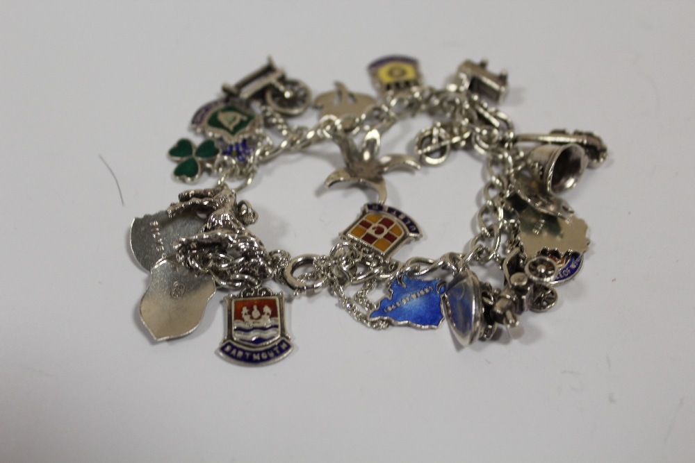 A STERLING SILVER CHARM BRACELET WITH ENAMELLED CHARMS