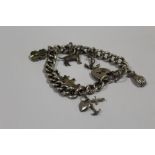 AN ANTIQUE SILVER CHARM BRACELET