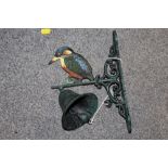 A CAST METAL WALL HANGING BELL WITH KINGFISHER FINIAL