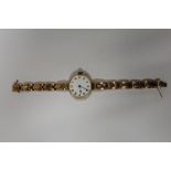 A VINTAGE HALLMARKED 9 CARAT GOLD CASED WRISTWATCH WITH ENAMEL DIAL ON 9CT GOLD EXPANDABLE BRACELET