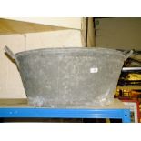 A LARGE METAL TWIN HANDLED TUB