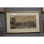 A GILT FRAMED AND GLAZED WATERCOLOUR DEPICTING A COUNTRY RIVER SCENE WITH CATTLE GRAZING