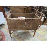 A VINTAGE WICKER COT