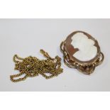 A LARGE VICTORIAN CAMEO BROOCH, TOGETHER WITH A ROLLED GOLD MUFF CHAIN (2)