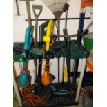 A PLASTIC GARDEN TOOL STAND PLUS GARDENING TOOLS