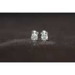 A PAIR OF 18ct WHITE GOLD SCREW BACK SOLITAIRE DIAMOND STUDS, boxed. Diamonds 1.14ct approx