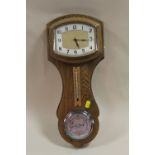 A LIGHT OAK GARRARD WALL BAROMETER/CLOCK