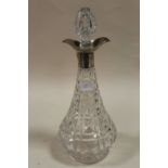 A LARGE CUT GLASS DECANTER WITH HALLMARKED SILVER COLLAR