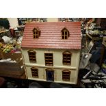 A VINTAGE WOODEN DOLLS HOUSE