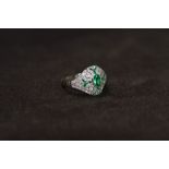 A PLATINUM VICTORIAN STYLE EMERALD AND DIAMOND DRESS RING, set with a central oval shaped emerald