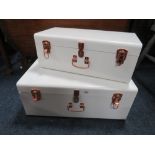 A MODERN WHITE METAL SET OF DECORATIVE TRUNKS - LARGEST W 60 cm