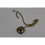 A 9CT GOLD BK & FT HEART LOCKET ON CHAIN