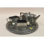 AN ART DECO HAMMERED FINISH PEWTER THREE PIECE TEA SERVICE ON TRAY, BY ARGENT