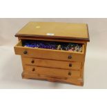 A PINE DESK TOP FOUR DRAWER CHEST CONTAINING A QUANTITY OF BEAD NECKLACES ETC., W 41 CM H 32 CM D 26