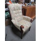 AN UPHOLSTERED ARMCHAIR