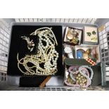 A BOX OF COSTUME JEWELLERY TO INCLUDE A 9CT BK & FT CIRCULAR LOCKET, SILVER AND AMBER BROOCH ETC.