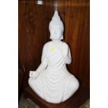 A LARGE WHITE RESIN SEATED BUDDHA FIGURE