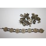 A SILVER CHARM BRACELET TOGETHER WITH A COIN BRACELET