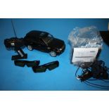 A RASTAR REMOTE CONTROL RANGE ROVER SPORT VEHICLE WITH STAND AND CHARGER TOGETHER WITH TWO PAIRS