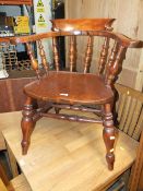 AN ANTIQUE WINDSOR SMOKERS BOW ARMCHAIR