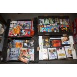 FOUR TRAYS OF DVDS