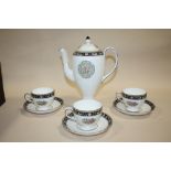 A WEDGWOOD RUNNYMEDE COFFEE POT AND THREE CUPS AND SAUCERS