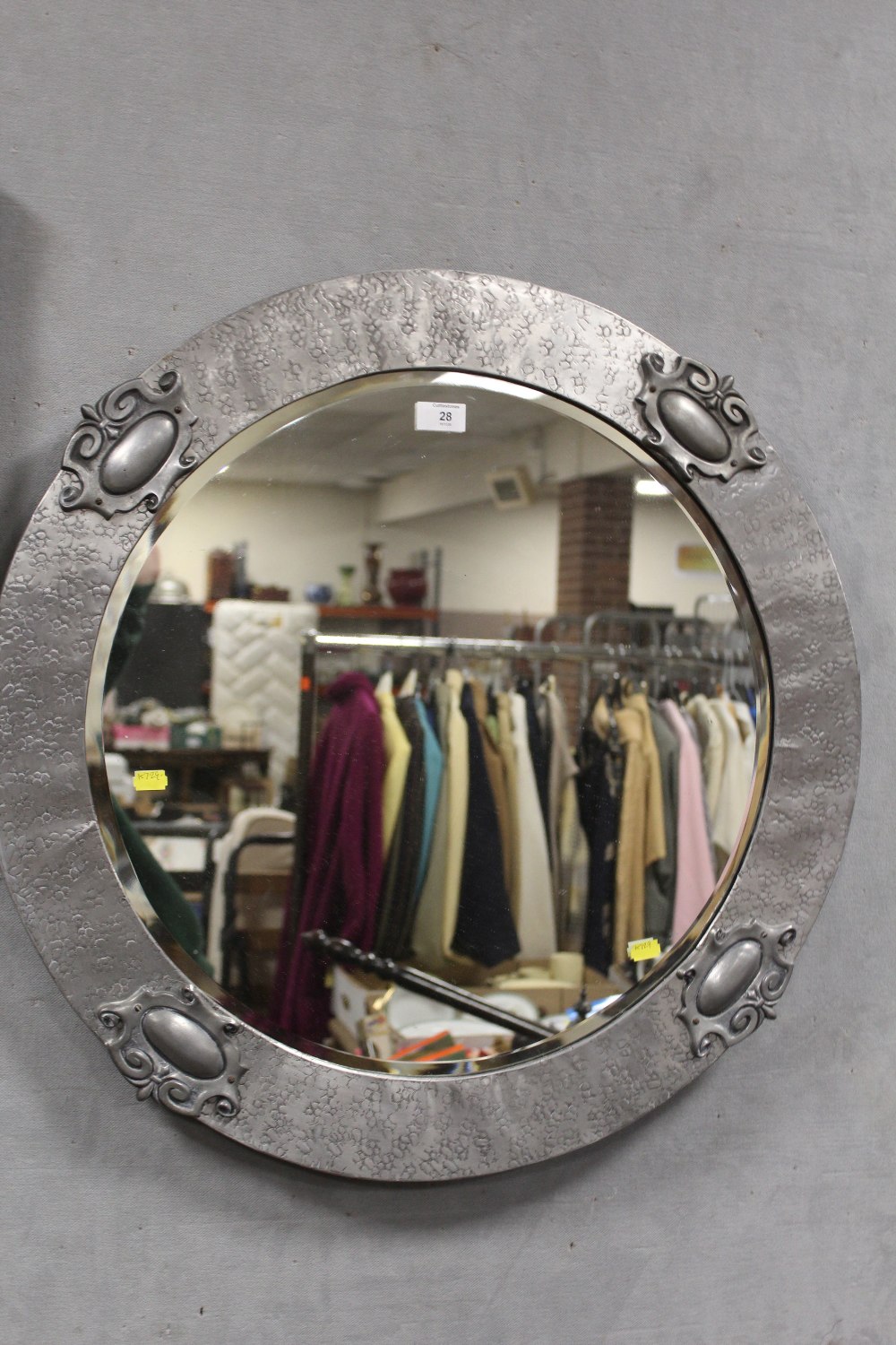 A SILVER FRAMED CIRCULAR BEVEL EDGED WALL MIRROR