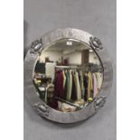 A SILVER FRAMED CIRCULAR BEVEL EDGED WALL MIRROR