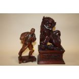AN ORIENTAL CARVED HARDWOOD DOG OF FOE ON PLINTH TOGETHER WITH A CARVED HARDWOOD FIGURE OF A