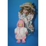 A SMALL ARMAND MARSEILLE BISQUE HEADED DOLL TOGETHER WITH A MODERN EXAMPLE