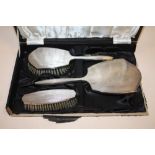 A HALLMARKED SILVER THREE PIECE BRUSH AND MIRROR SET