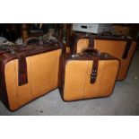 A SET OF THREE CUSTOM LEATHER SUITCASES