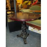 A CIRCULAR PUB TABLE WITH CAST LEGS K285