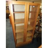 A MODERN PINE GLAZED FLOORSTANDING BOOKCASE WITH TWO DRAWERS H-183 W-80 CM