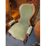 A VICTORIAN MAHOGANY FRAMED GENTLEMANS ARMCHAIR WITH CARVED DETAIL