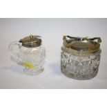 A HALLMARKED SILVER TOPPED CUT GLASS CONDIMENT JAR TOGETHER WITH A SILVER PLATED CUT GLASS SUGAR