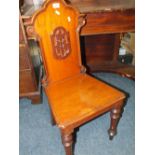 AN ANTIQUE MAHOGANY HALL CHAIR WITH CARVED DETAIL