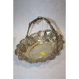 A HALLMARKED SILVER SWING HANDLED FLORALLY EMBOSSED BASKET APPROX WEIGHT - 393.3G